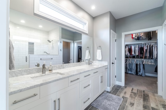 bathroom with vanity and a shower with shower door