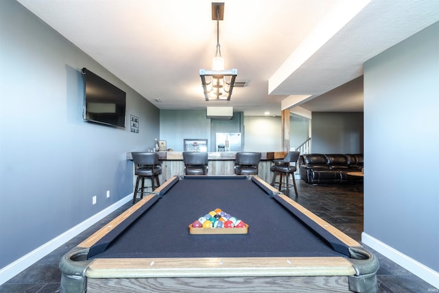 game room with pool table and bar area