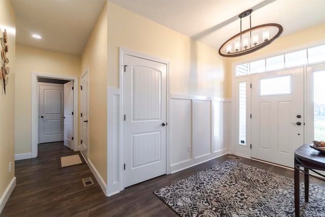 entryway featuring a notable chandelier and dark hardwood / wood-style flooring