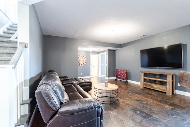 living room with a textured ceiling and dark hardwood / wood-style flooring