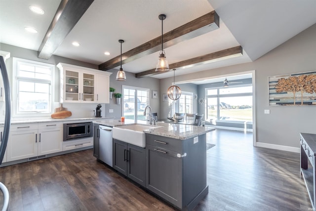 kitchen with sink, dark hardwood / wood-style flooring, white cabinetry, stainless steel appliances, and decorative light fixtures