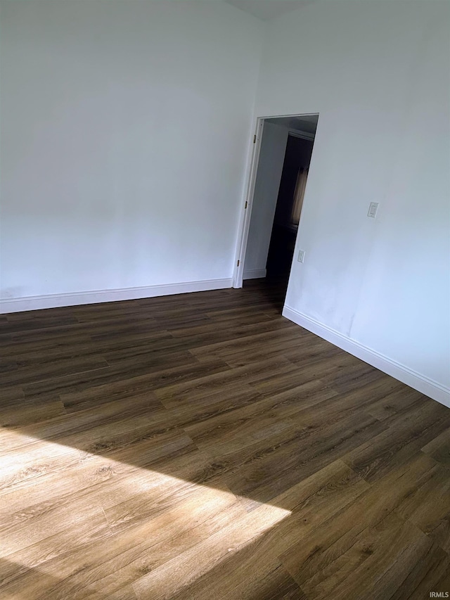 empty room featuring dark wood-type flooring