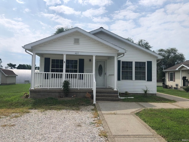 bungalow-style home with a front yard and a porch