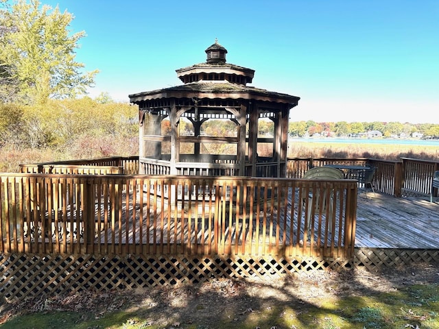 wooden terrace with a gazebo and a water view