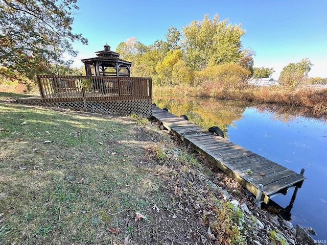 view of dock featuring a gazebo and a water view