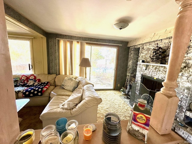 living room with carpet flooring and a stone fireplace