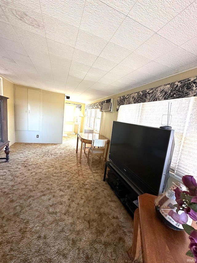 living room featuring carpet flooring and a wall unit AC