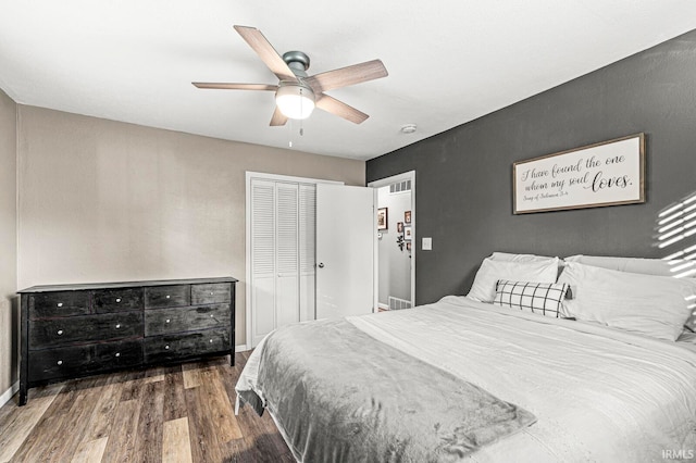 bedroom featuring a closet, ceiling fan, and dark hardwood / wood-style floors