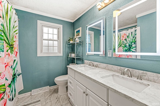 bathroom with vanity, toilet, ornamental molding, and a textured ceiling