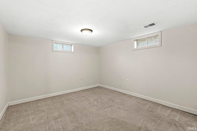 basement featuring light colored carpet