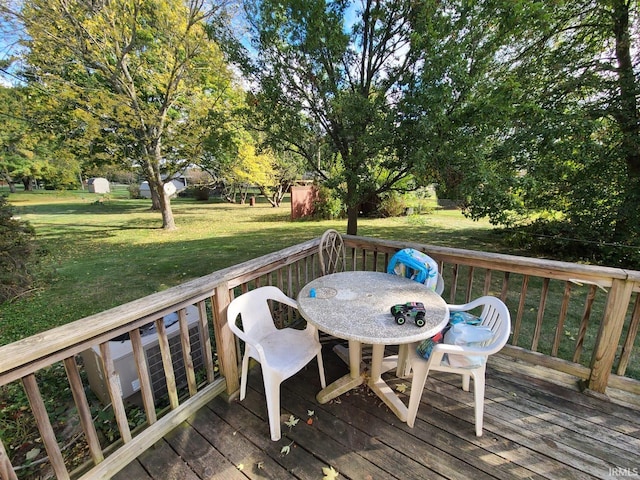 wooden deck with a lawn