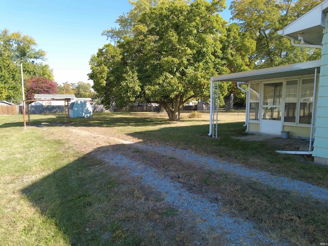 view of yard featuring a storage unit