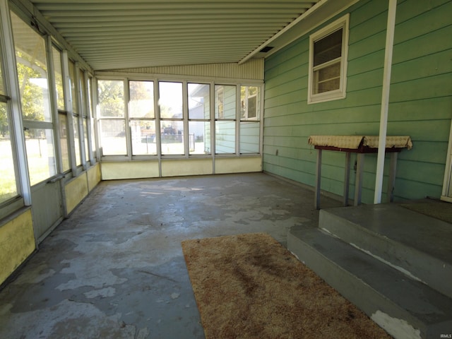 unfurnished sunroom featuring lofted ceiling