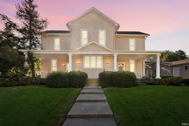 view of front facade featuring a yard and a porch