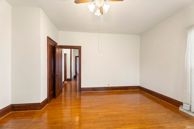 unfurnished room with ceiling fan and hardwood / wood-style flooring