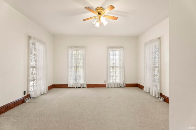 empty room with light carpet and ceiling fan