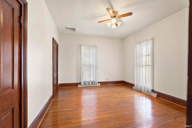 empty room featuring light hardwood / wood-style flooring and ceiling fan