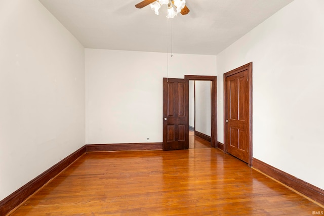 spare room with ceiling fan and hardwood / wood-style floors