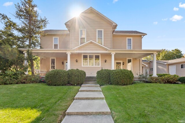 view of front of property with a porch and a front yard