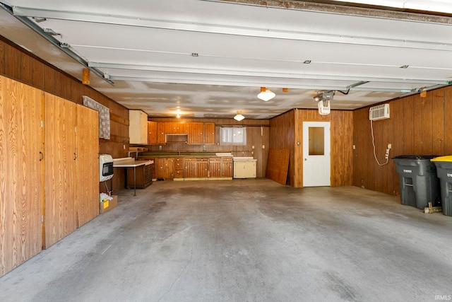 garage featuring an AC wall unit and wooden walls