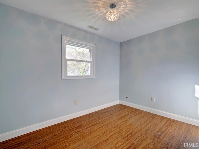 unfurnished room featuring wood-type flooring