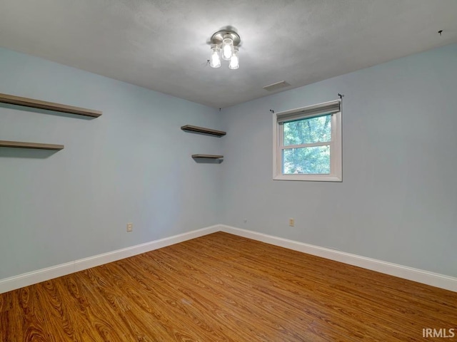 empty room with hardwood / wood-style floors