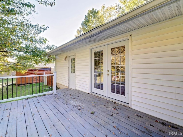 deck featuring french doors and a yard