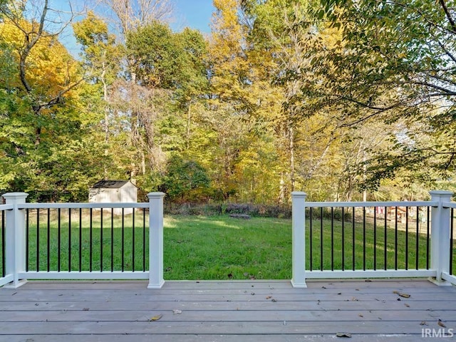 wooden terrace featuring a yard