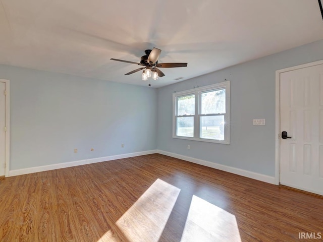 spare room featuring hardwood / wood-style floors and ceiling fan