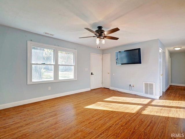 spare room featuring light wood-type flooring and ceiling fan