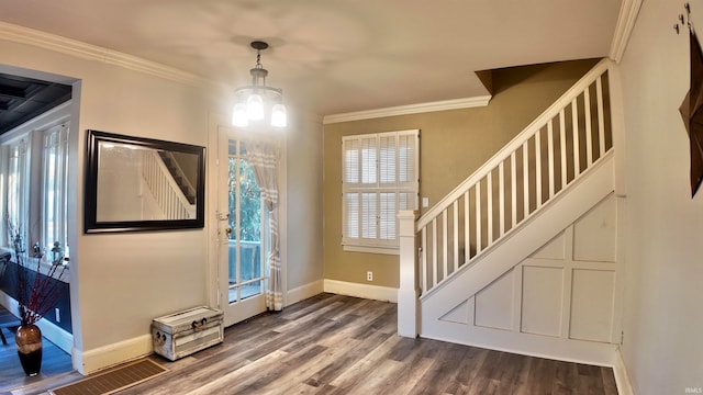 entryway featuring ornamental molding, an inviting chandelier, and dark hardwood / wood-style floors