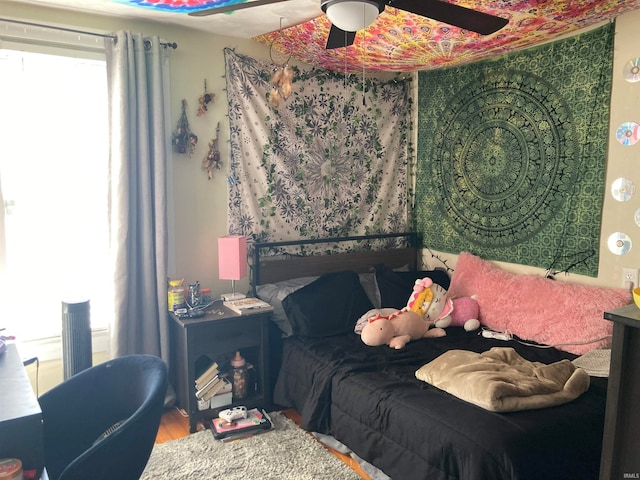 bedroom featuring hardwood / wood-style floors and ceiling fan