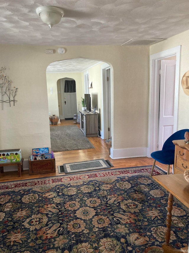 hall featuring hardwood / wood-style floors and a textured ceiling