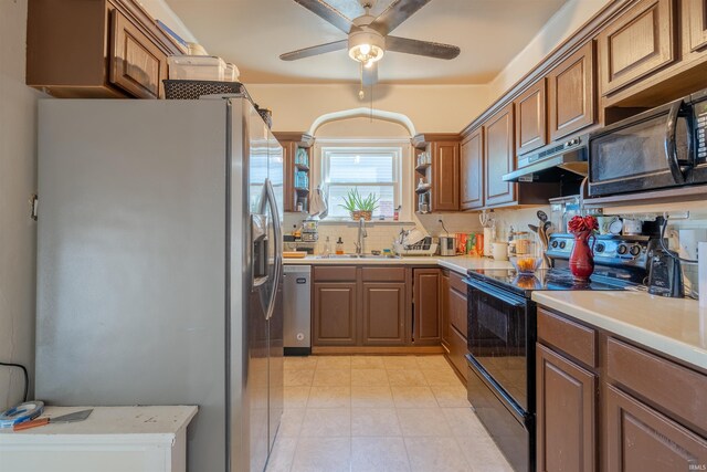 kitchen with ceiling fan, black appliances, sink, and decorative backsplash