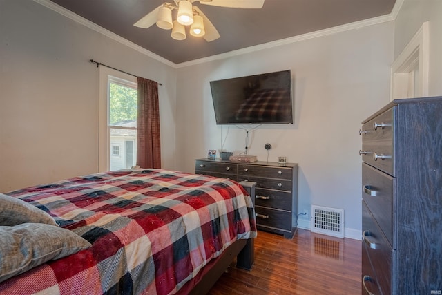 bedroom with dark wood-type flooring, ceiling fan, and crown molding