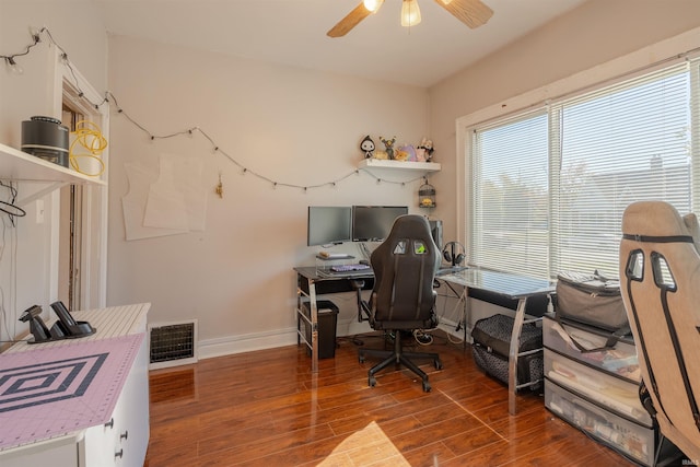 office featuring a healthy amount of sunlight, hardwood / wood-style flooring, and ceiling fan