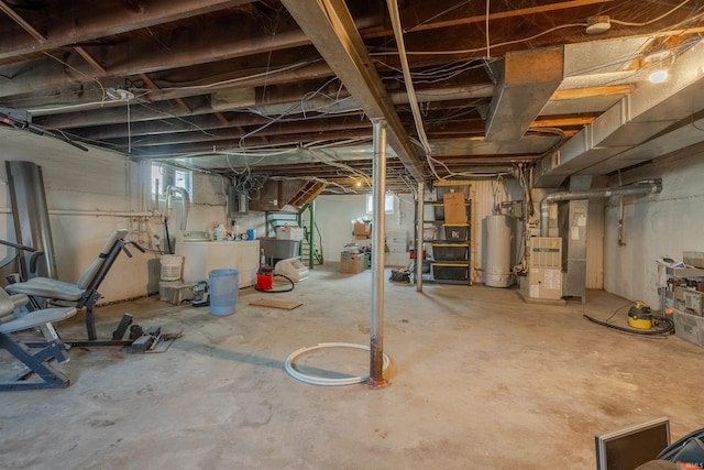 basement with water heater, electric panel, heating unit, and washer and clothes dryer