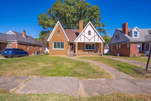 view of front facade with a front lawn, central AC unit, and covered porch