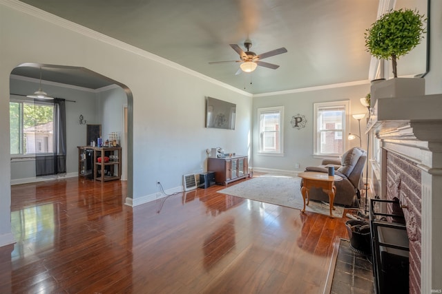 living room with ornamental molding, hardwood / wood-style flooring, and ceiling fan