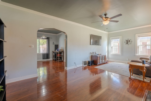 living room featuring ornamental molding, wood-type flooring, and ceiling fan