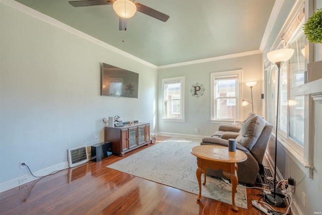 living room featuring crown molding, wood-type flooring, and ceiling fan