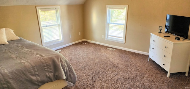 carpeted bedroom featuring vaulted ceiling and multiple windows