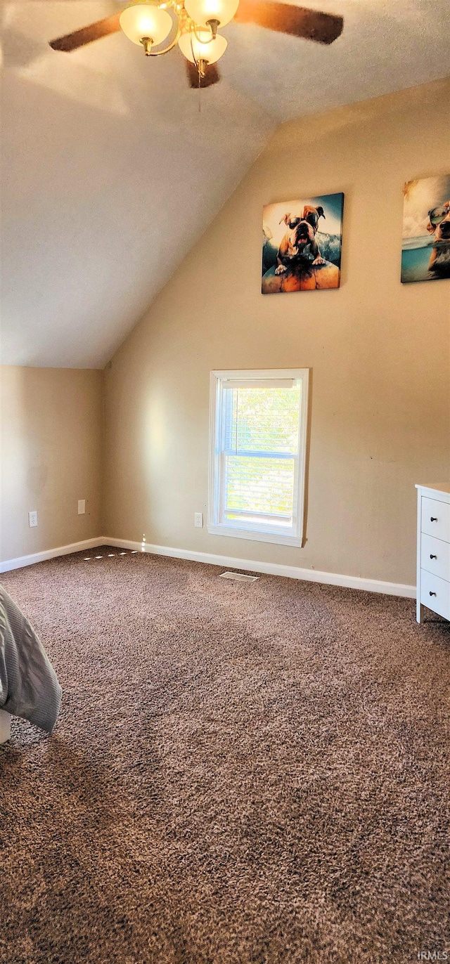 bonus room with lofted ceiling, a textured ceiling, carpet, and ceiling fan