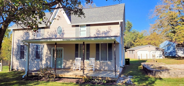 view of front of house with a storage unit, a front lawn, and a wooden deck