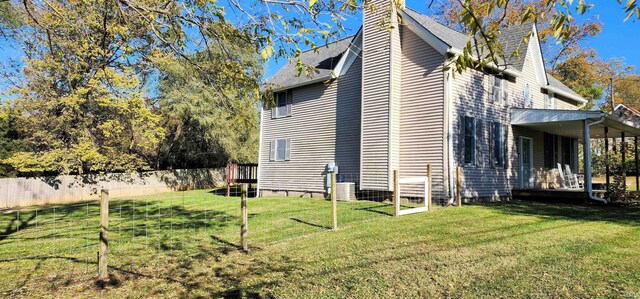 view of side of home with a lawn