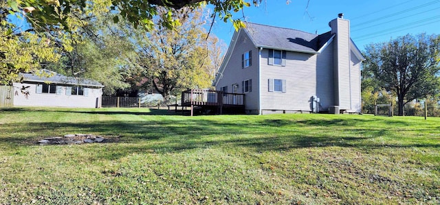 exterior space featuring a deck and a lawn