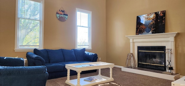 living room with a healthy amount of sunlight, carpet flooring, and a fireplace