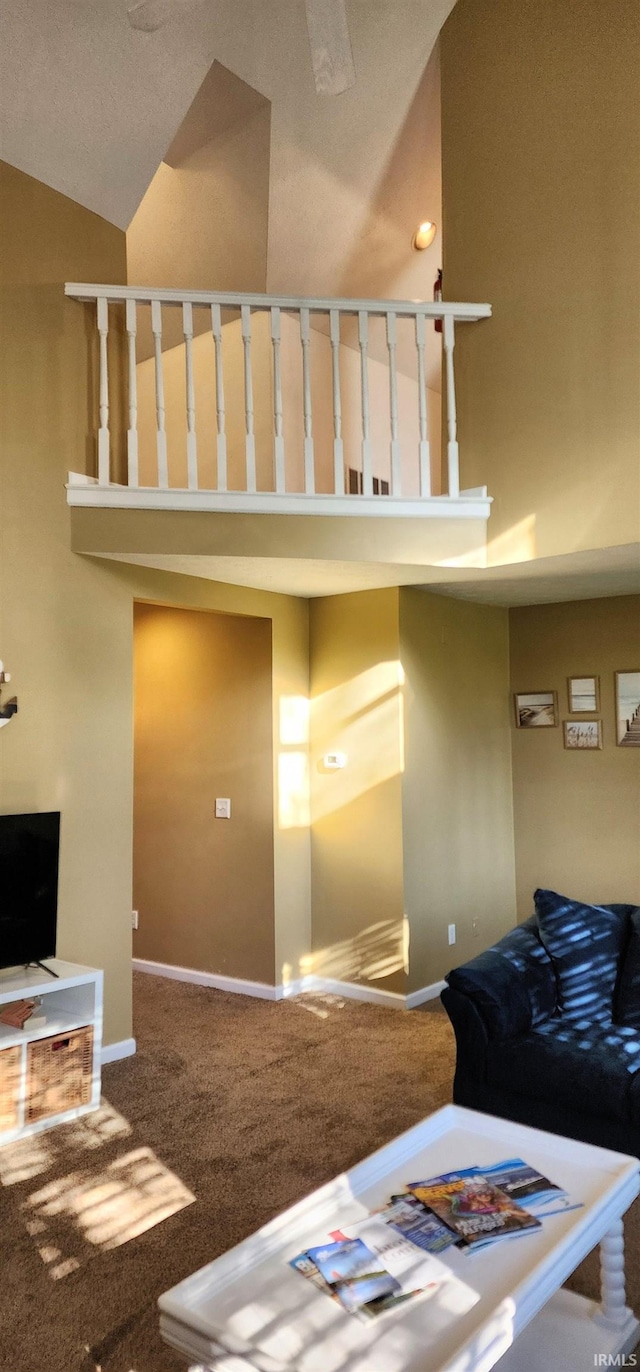 interior space featuring vaulted ceiling, a textured ceiling, and carpet floors