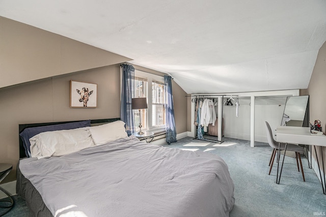 bedroom with carpet flooring and vaulted ceiling