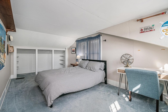 carpeted bedroom with lofted ceiling